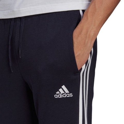 Spodnie adidas Essentials Fleece Tapered Cuff 3-Band M GK8823 Adidas